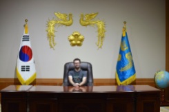 Dan sitting behind a replica of the President's desk.